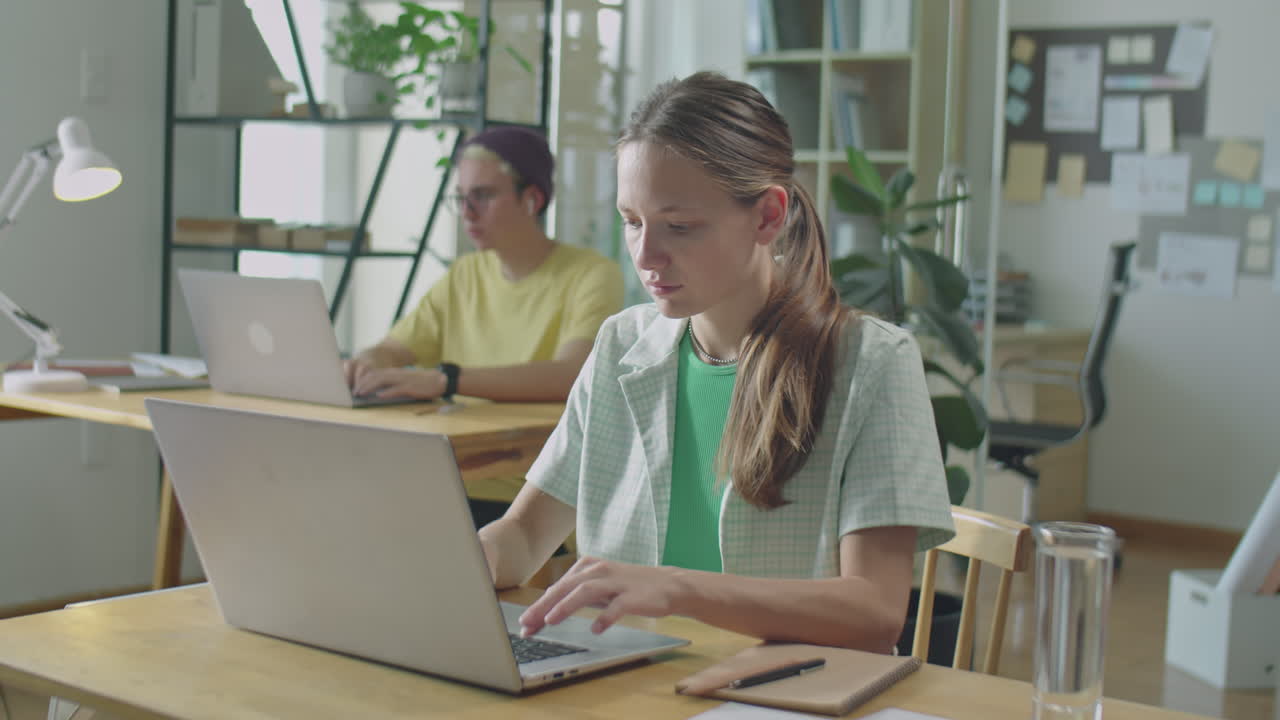 Gen Z Girl Using Laptop at Work in Office