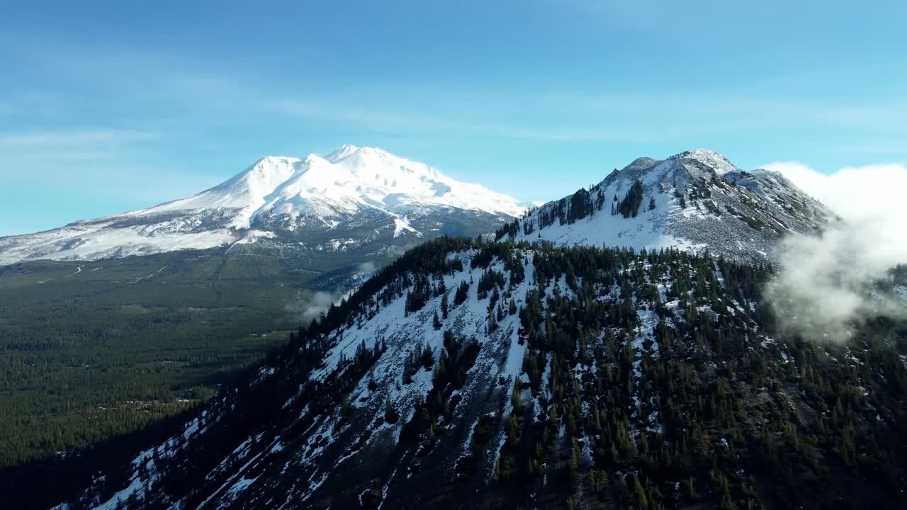 USA, CA, Weed, , 2024-12-27 - Drone view of Mt Shasta in winter with Black Butte in the foreground