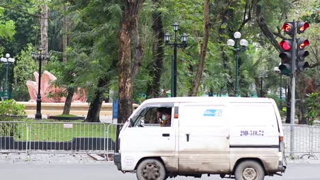 vehicles and motorbikes at a busy hanoi intersection