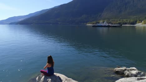 Mujer-Realizando-Yoga-En-La-Orilla-Del-Lago-4k