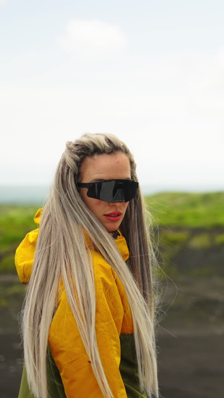 Young Woman in Yellow Jacket and Sunglasses Outdoors