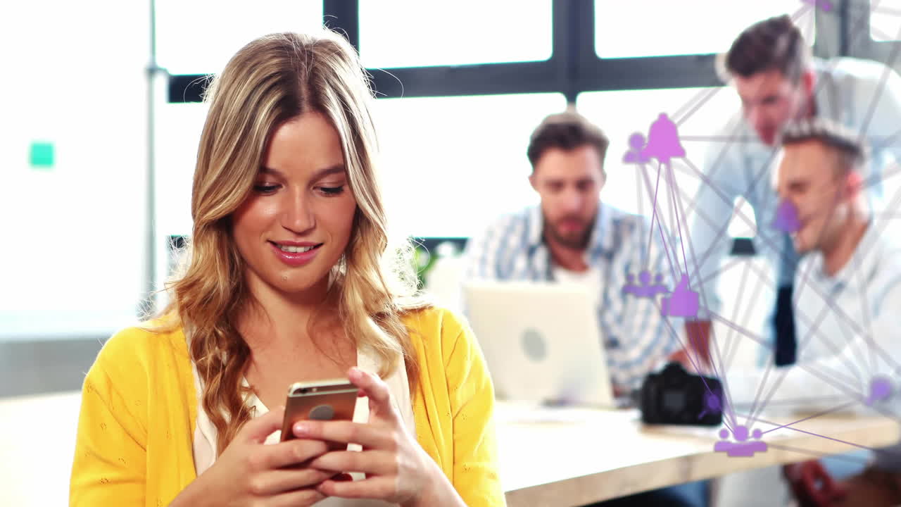 Animation of media icons over diverse business people using smartphone