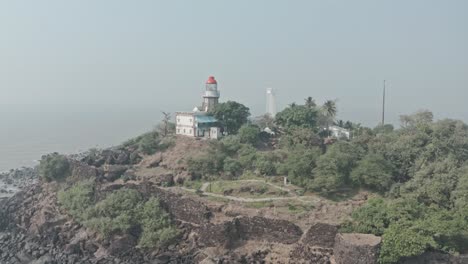 circling drone shot of indian lighthouse on fort island