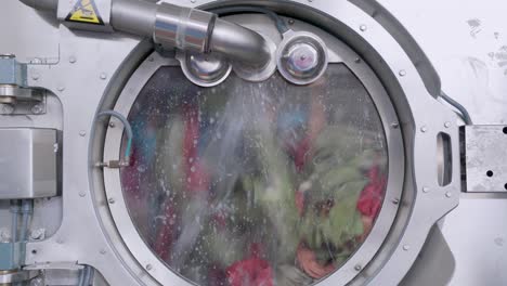 4k video of industrial washing machine is washing a big amount of textiles