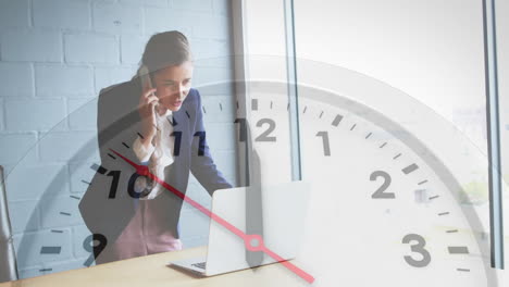 animation of clock moving over caucasian businesswoman talking on smartphone in office