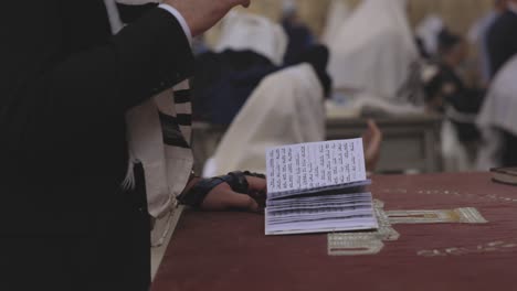 jewish man opening a torah scroll