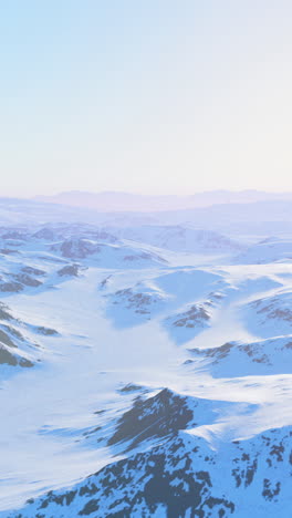 snowy mountain range with blue sky