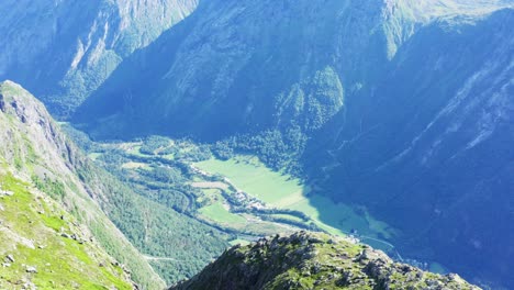 view of beautiful green valley below in katthammaren norway - tilt down shot