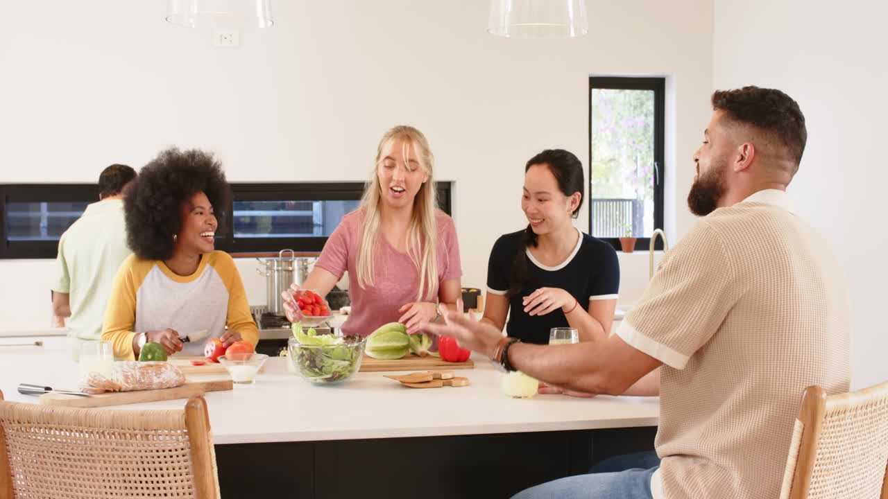 Preparing meal, group of young friends chopping vegetables in kitchen