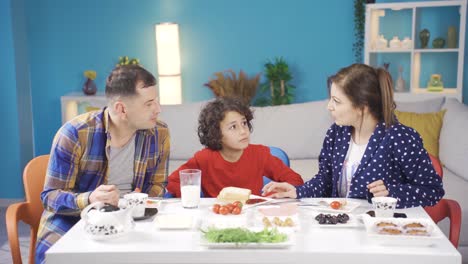 Troubled-parents-fight-at-the-breakfast-table,-and-the-disturbed-little-boy-separates-them.