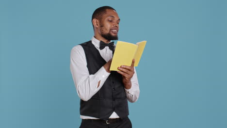 Doorkeeper-classy-staff-enjoying-a-literature-book-against-blue-background