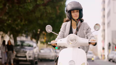 woman riding a scooter in the city