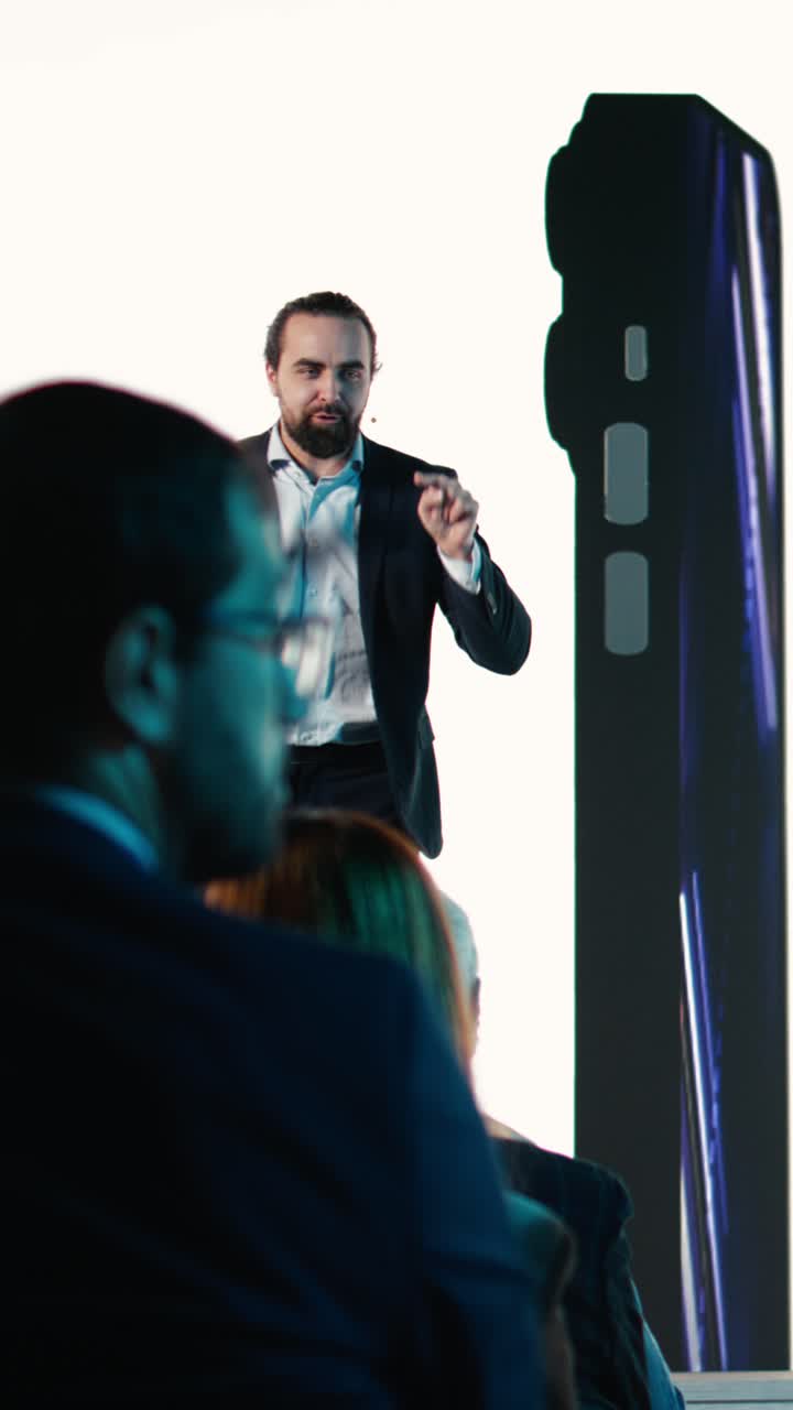 Vertical Video Male CEO presenting new mobile phone product launch on stage