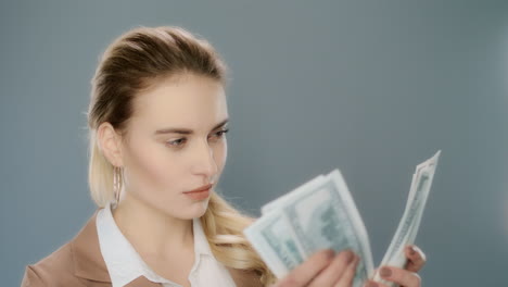 Serious-businesswoman-counting-cash-money