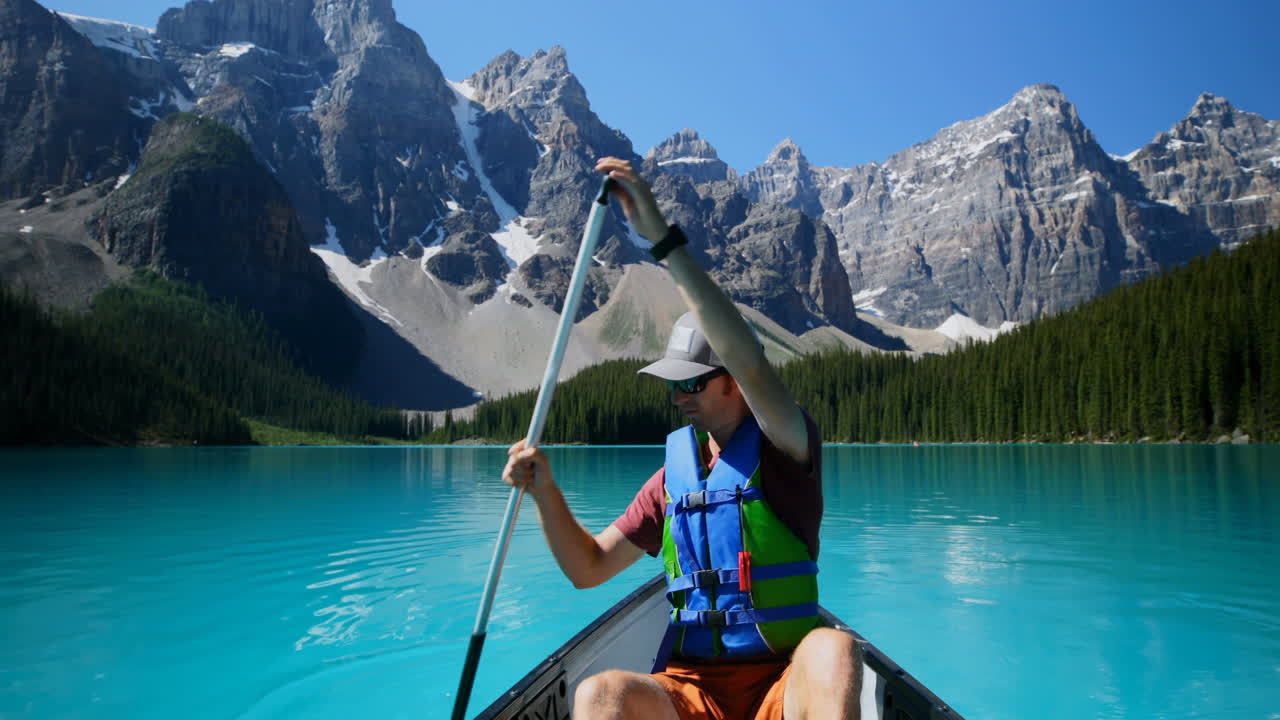 Man rowing a boat in river at countryside 4k