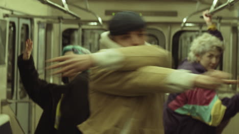 group of young dancers dancing in subway