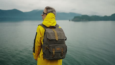 woman hiking by the lake in rain gear