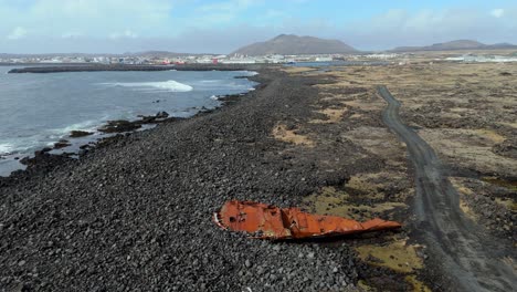 aerial view of iceland, fisherman ship wreck in black sand beach of grindavik abandoned boat