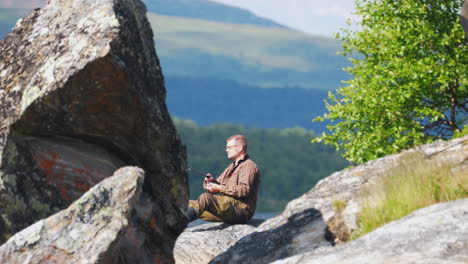 Static-shot-of-calm-relaxed-man-fishing-in-amazing-scenery,-Alaska