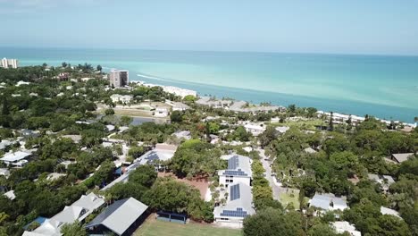 slow flyover of siesta key florida towards the turquoise gulf water