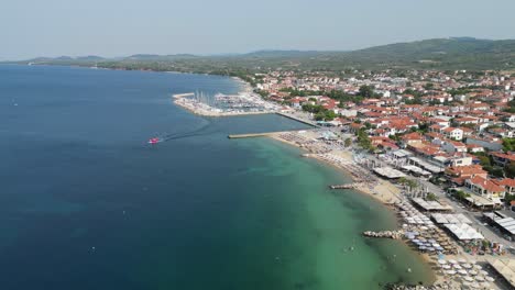 Nikiti-Village-and-Popular-Holiday-Destination-in-Sithonia,-Halkidiki,-Greece---Aerial-4k