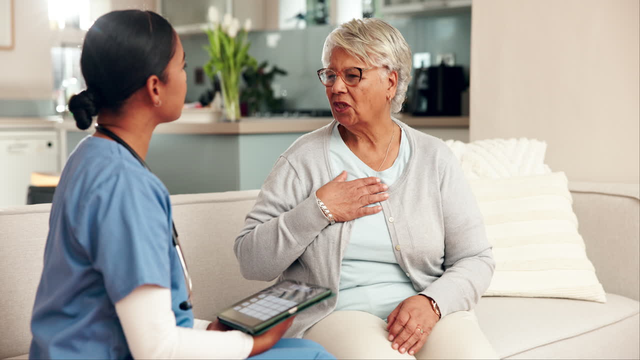 Healthcare professional consulting with elderly patient