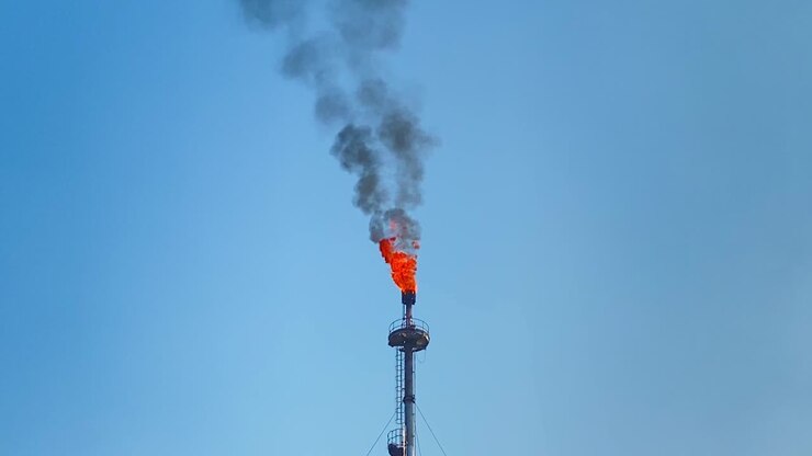 Fire and dark smoke rise from gas plant tower in Bangladesh, static
