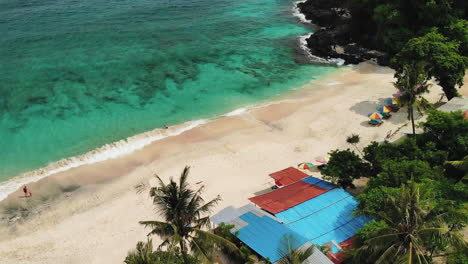 Top-down-travel-shot-of-a-small-quiet-beach-in-Bali