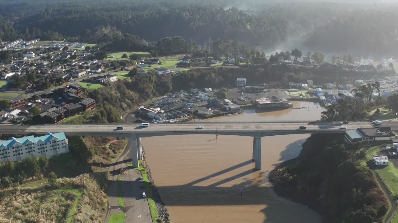 Wide aerial pullback shot of the Noyo River Bridge in Fort Bragg, California. 4K