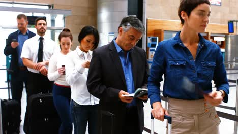 Commuters standing in queue for check-in