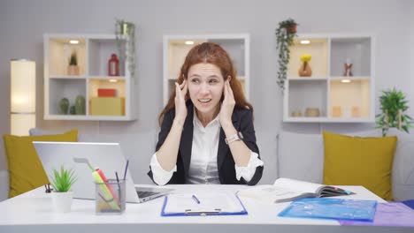 Home-office-worker-woman-scratches-her-ears-looking-at-camera.