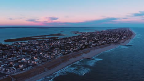 Empty-Long-beach-island-at-charming-colorful-sunset,-New-Jersey,-with-pink-horizon,-establishing-shot