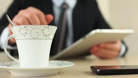 Businessman-Tea-Time-And-Using-Tablet-1