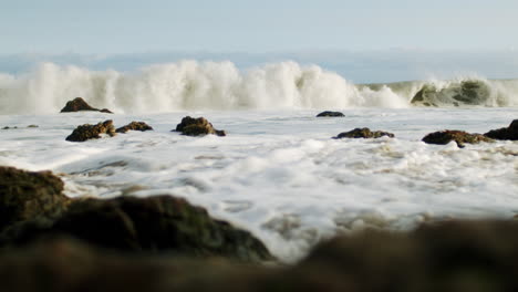powerful ocean waves crashing on a rocky shore