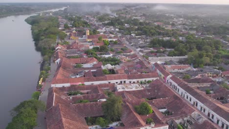 the view moves from the town to reveal magdalena river bathed in the soft hues of twilight. yaw left.