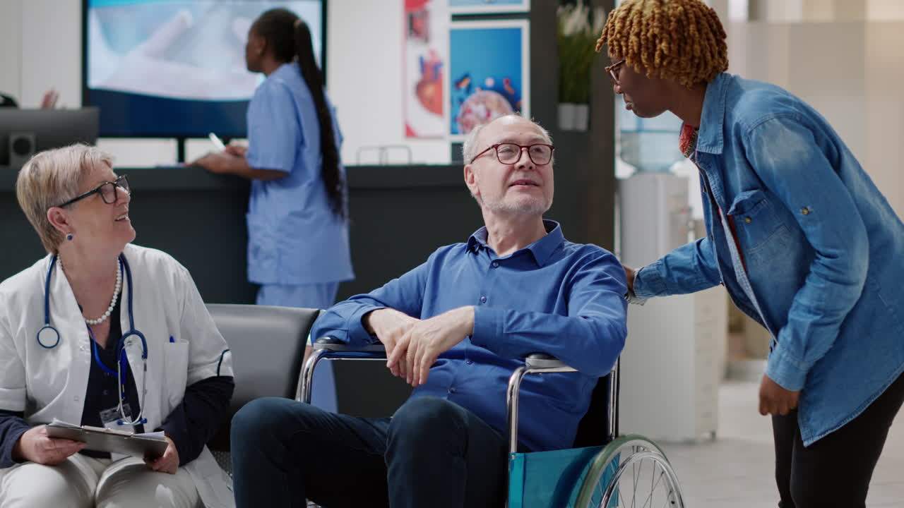 Medical Personnel Assisting Patient in Wheelchair at Hospital