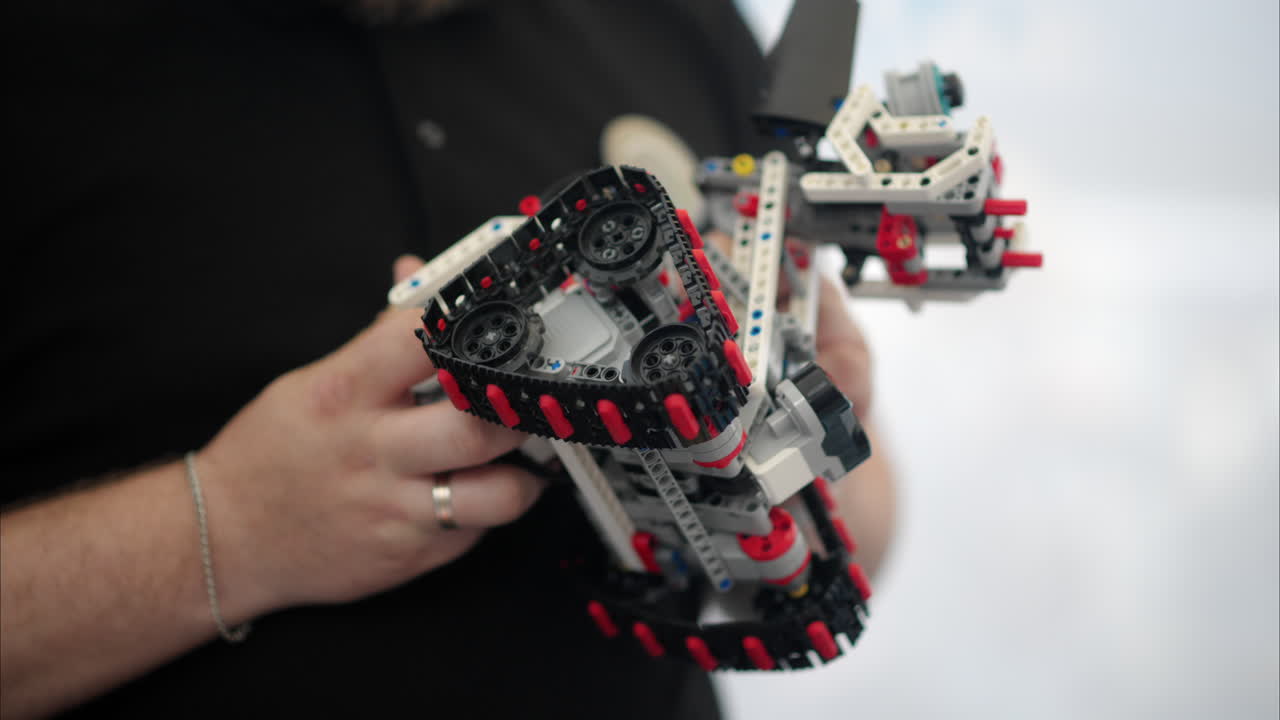 Man analysing a moving robot, slow motion