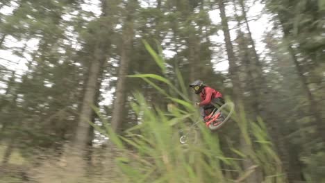 mountain bike rider jumping sideways over a large jump in the bike park