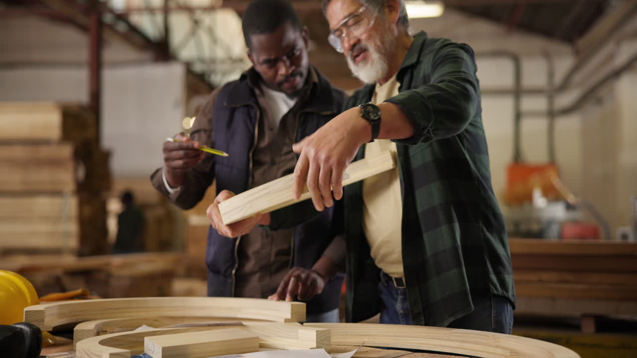 Carpentry workshop with two men working on a wooden project