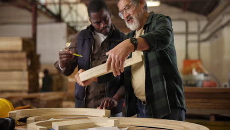 carpentry workshop with two men working on a wooden project