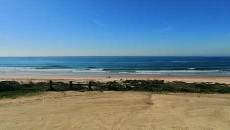 view from car parking to empty atlantic beach - wide shot