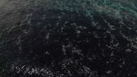 a scenic view of costa rica beach with blue waves under the beautiful sky.- aerial shot