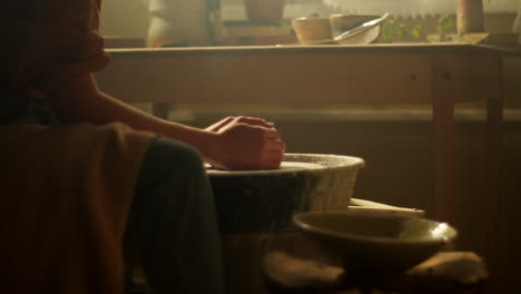 woman working on pottery wheel