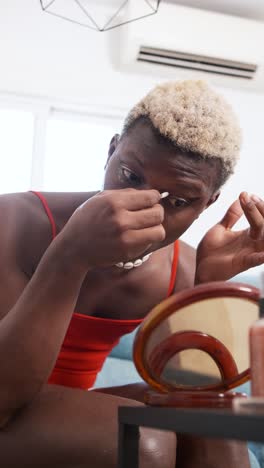 individual applying eye makeup