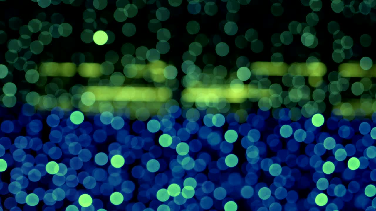 Night abstract background is defocused with nice bokeh. Blurred Christmas Lights Bokeh. Pan across blur .