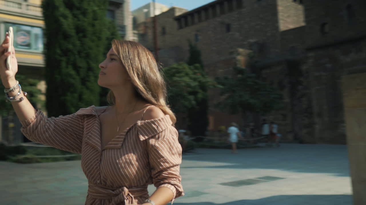 Focused woman searching wifi in the street