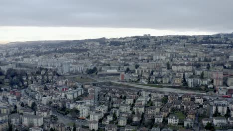 Drone-Aerial-of-the-beautiful-swiss-city-center-of-lausanne-located-on-the-lake-geneva-in-Switzerland-during-winter,-Europe