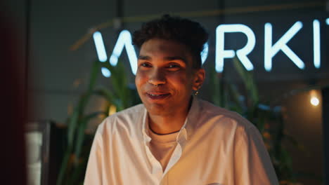 happy man talking at night club interior closeup. carefree guy discussing news