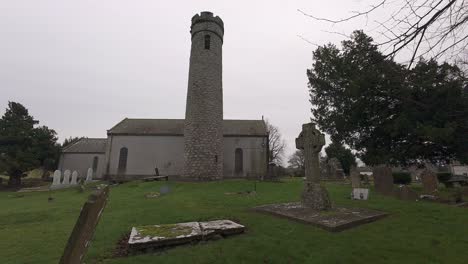 historic site with round tower and ancient high cross at castledermot kildare ireland