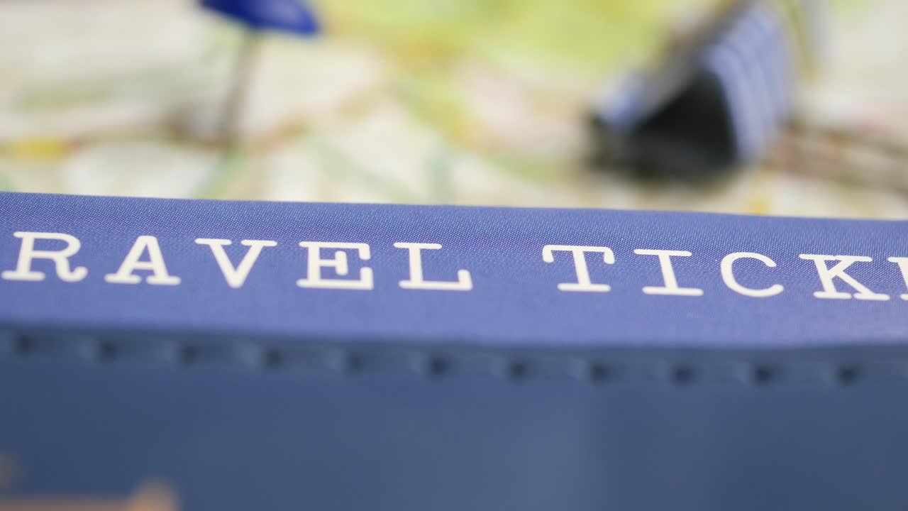 Close-up of Travel Ticket Text on Blue Holder